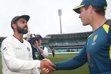 India captain Virat Kohli and Australia captain Tim Paine shake hands at the SCG after the Test series between their teams.