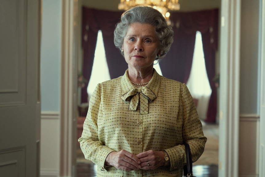 A still of Imelda in a yellow outfit.