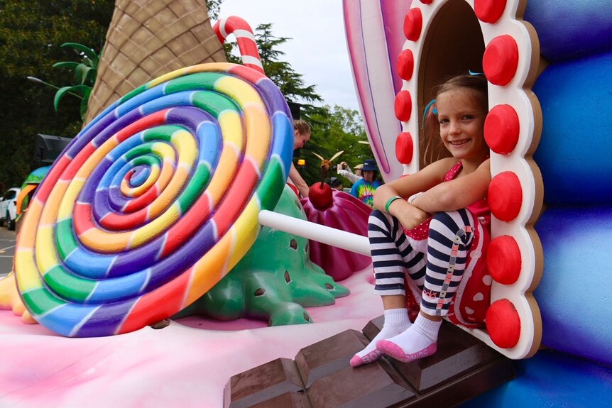 A girl sits on a confectionary-themed float ahead of the Moomba festival.