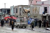 Afghan police officers inspect the site of a car bomb attack in Kabul.