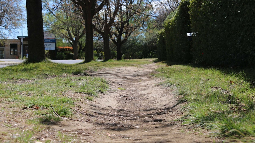 A dirt path in a Canberra street.