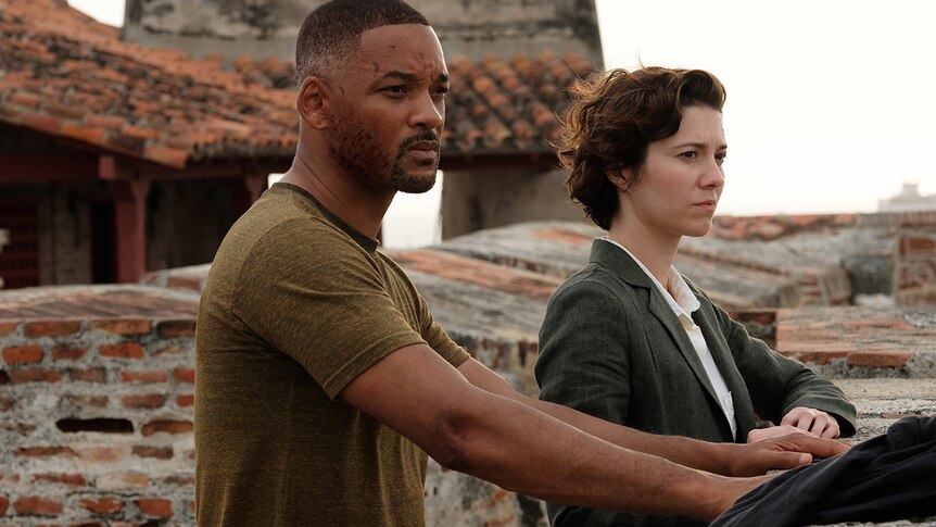Will Smith (left) and Mary Elizabeth Winstead look off into distance from a bricked and tiled rooftop.