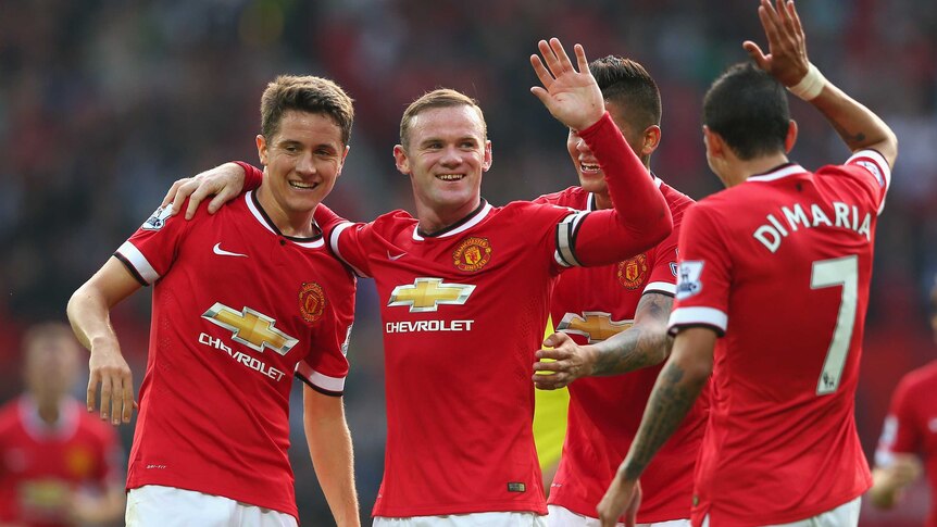 Manchester United celebrates a Wayne Rooney goal