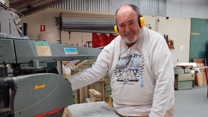 Ulverstone Men's Shed member Len Blair stands at a drop saw in the Ulverstone Men's Shed.