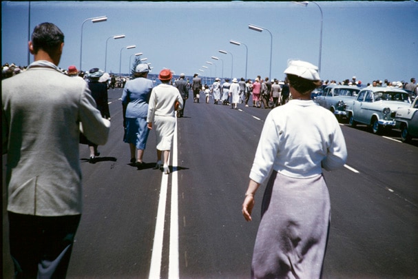 Guests walk across the Narrows Bridge on the day it opened, November 13, 1959