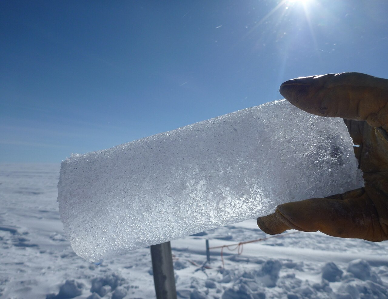 A hand holding an ice core