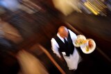 Waiter carries dishes, good top-down generic