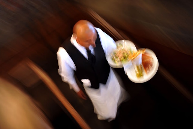 Waiter carries dishes, good top-down generic