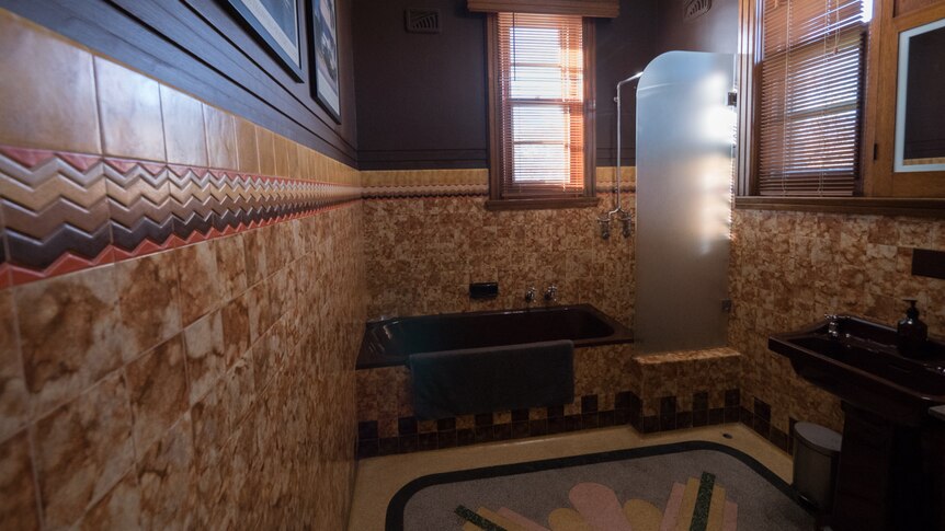 Four different tile styles are used in the bathroom.