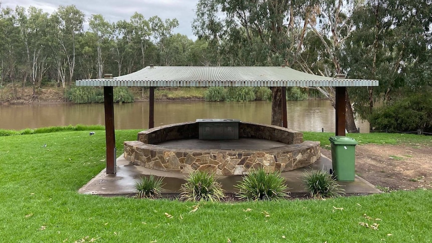 Shaded barbeque area in front of a river