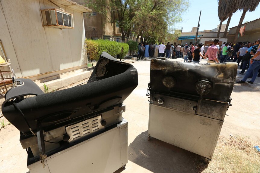 Burnt incubators stand outside the Yarmuk hospital.