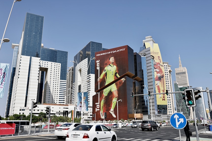 A banner of Germany goalkeeper Manuel Neuer hangs off the side of a building in Qatar