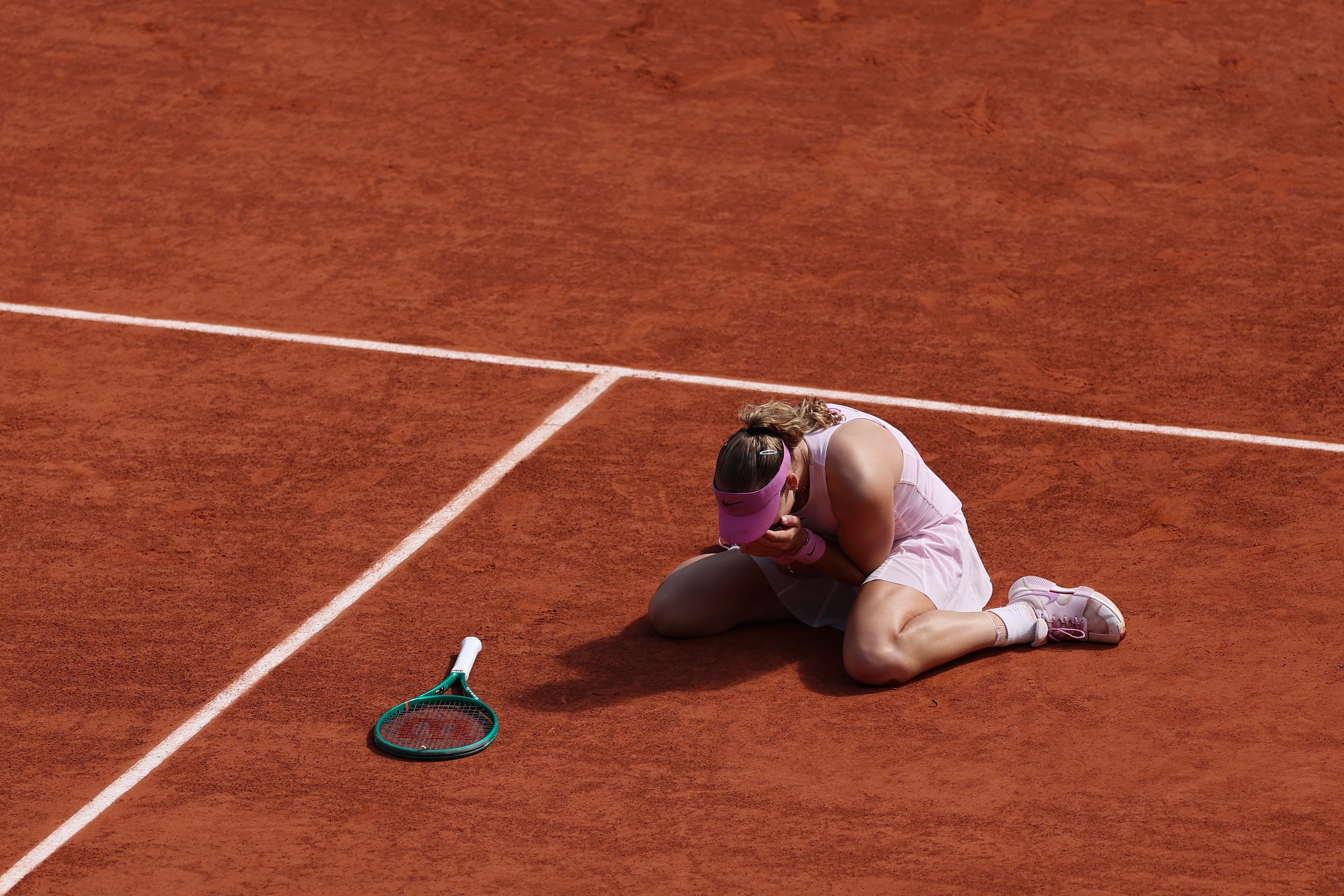 Mirra Andreeva drops to her knees after French Open final.