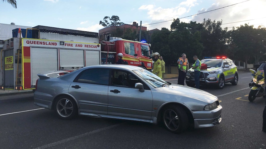 The car involved in the incident on the street in front of a fire truck.