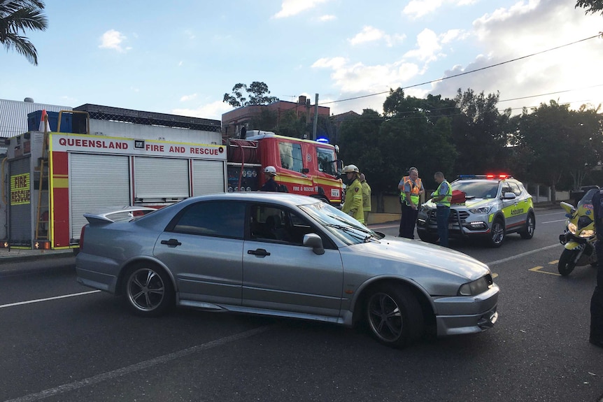 The car involved in the incident on the street in front of a fire truck.