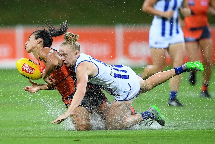 Amanda Farrugia of the Giants is tackled by Emma Humphries of the Kangaroos.