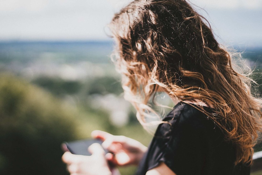 Woman looking down at phone