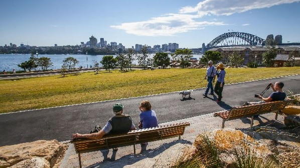 Sydneysiders walking through the reserve on the harbour side.