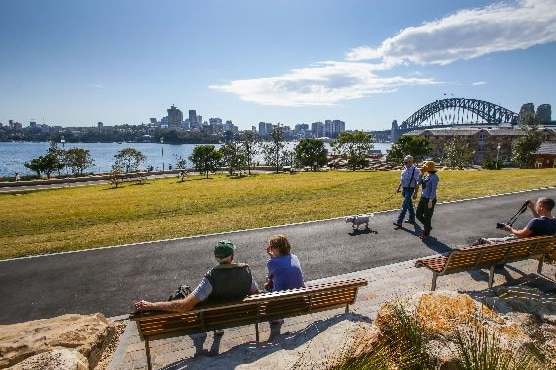 Sydneysiders walking through the reserve on the harbour side.