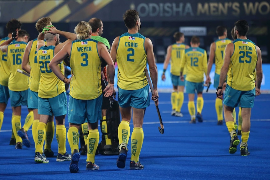 Male hockeyplayers on the field after the game