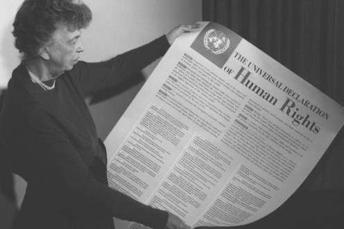 A black-and-white photo shows Eleanor Roosevelt and the United Nations Universal Declaration of Human Rights.