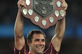 Cameron Smith holds the State of Origin shield aloft for Queensland in 2013.