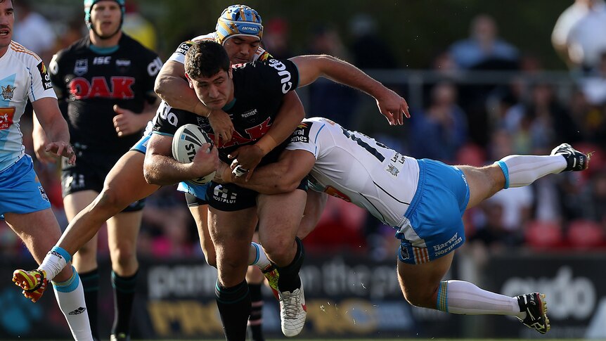 Sam McKendry powers his way through the Titans defence.
