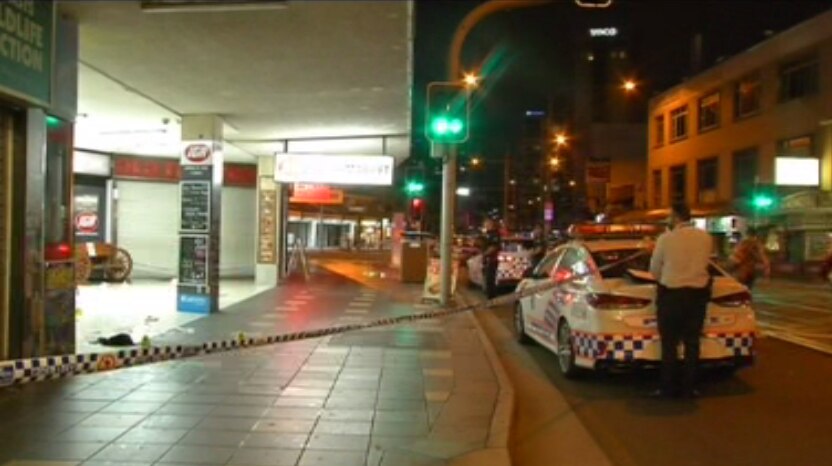 Police tape and officers at scene of a fatal stabbing on Surfers Paradise Boulevard.