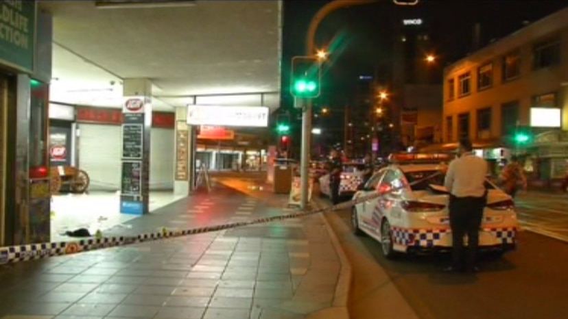 Police tape and officers at scene of a fatal stabbing on Surfers Paradise Boulevard.