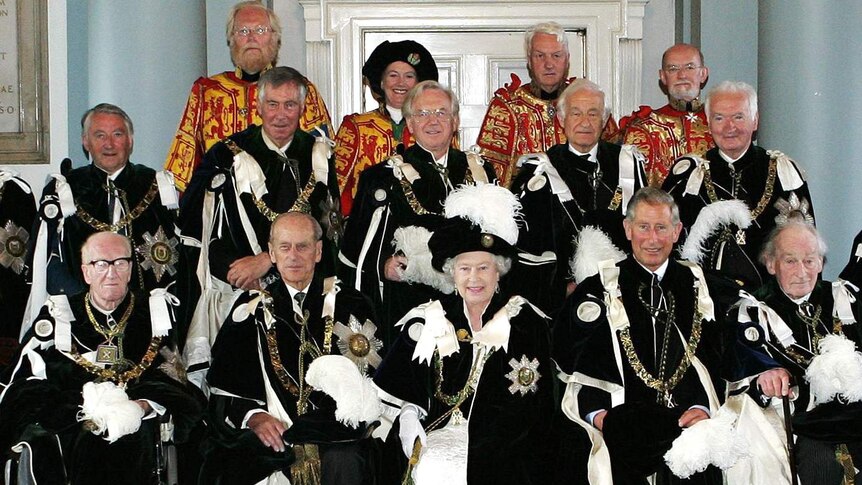 Queen Elizabeth II (C) poses with the Knights of the Thistle