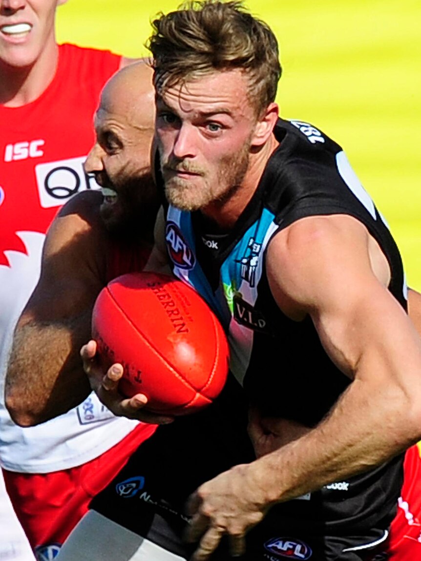 John McCarthy of Port Adelaide breaks a tackles during a match against the Sydney Swans.