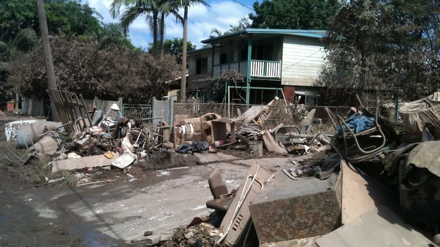 Damaged household goods and debris scatter a flood-affected street in Goodna (User submitted: Dennis)