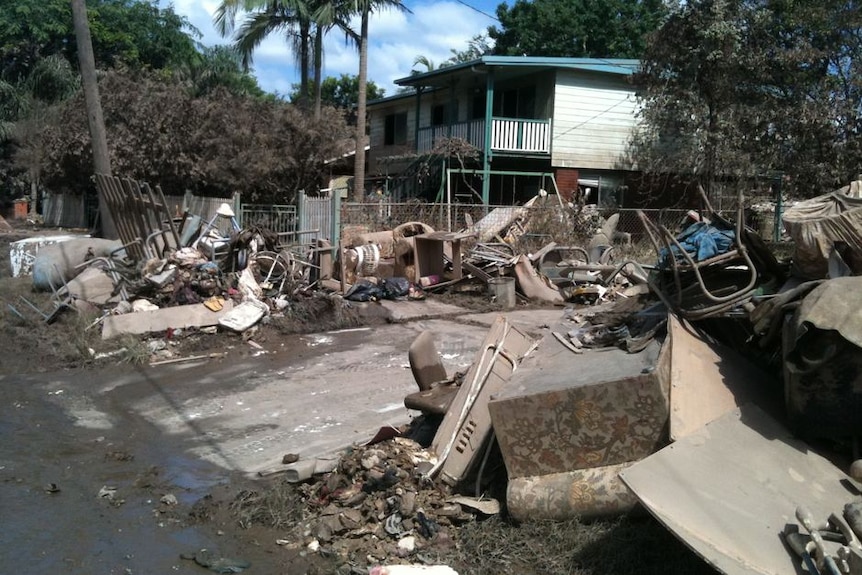Damaged household goods and debris scatter a flood-affected street in Goodna (User submitted: Dennis)
