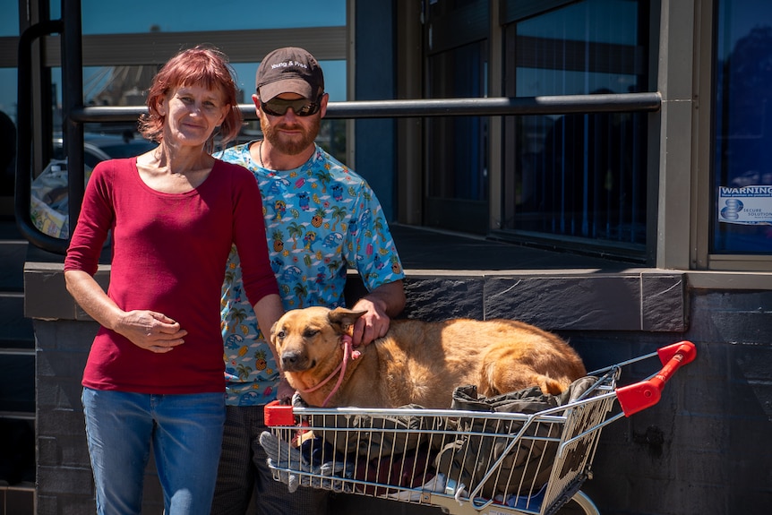 Toowoomba locals Michelle and Rob, next to a trolley with a dog in it, March 2021.