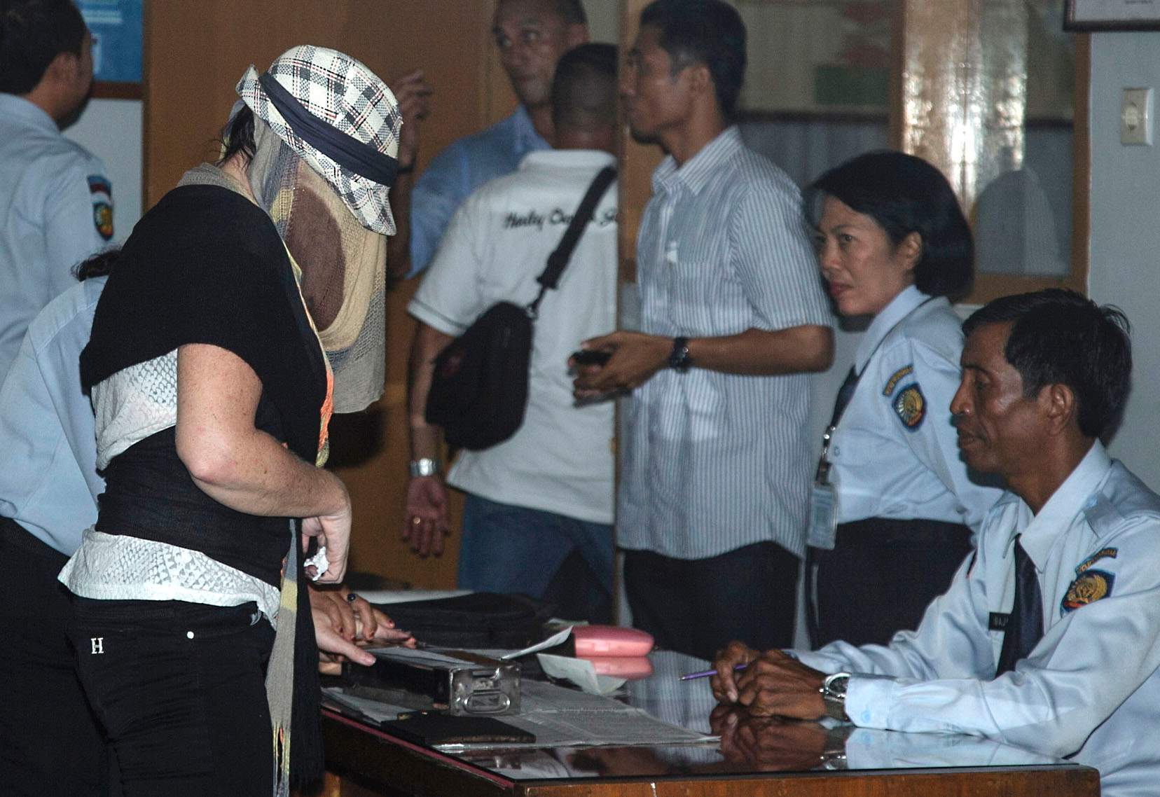 Convicted drug smuggler Schapelle Corby has her fingerprint taken as she leaves prison.