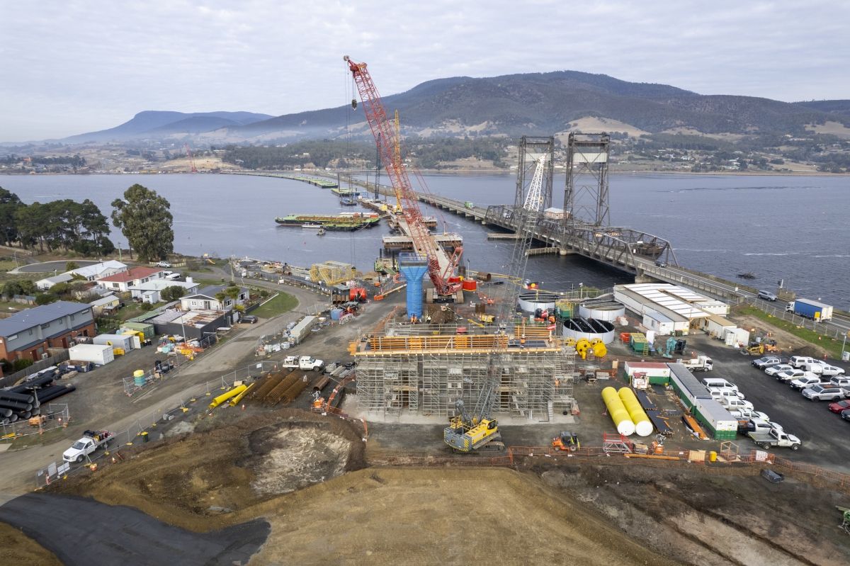A building site beside the river Derwent shows the first pier of a bridge over a river