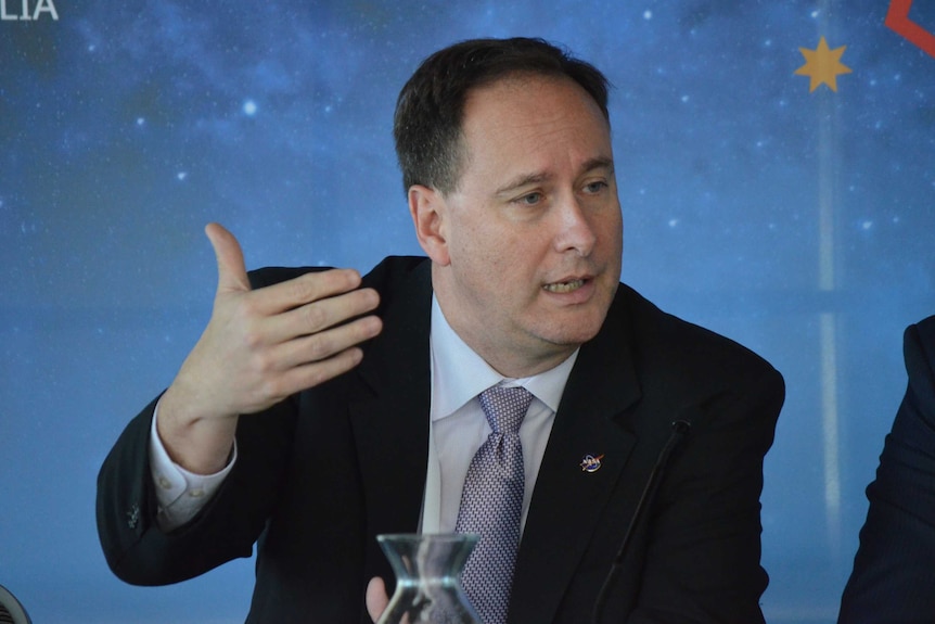 NASA administrator Robert Lightfoot gestures with his hand as he speaks.