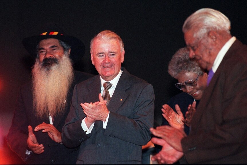 Patrick Dodson, Sir William Deane, Faith Bandler and Joe McGuinness stand on the stage of the Reconciliation conference.