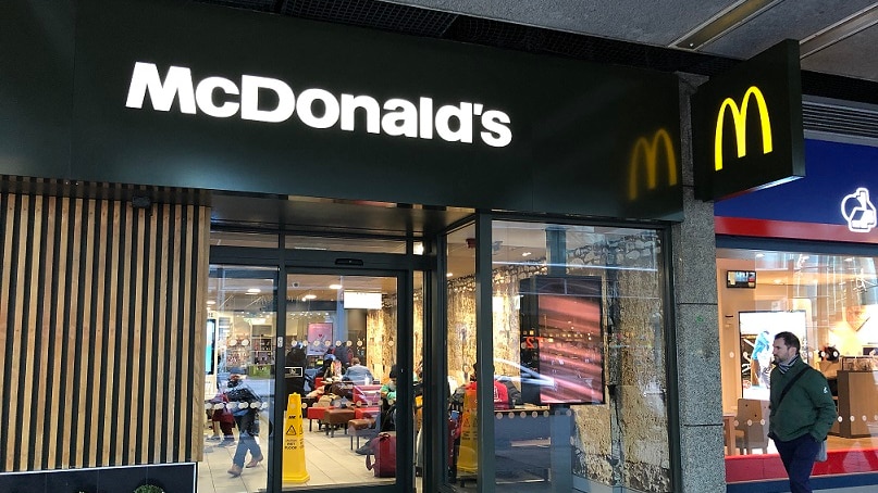 A man walks past McDonald's in the UK.