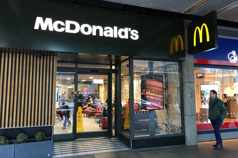 A man walks past McDonald's in the UK.