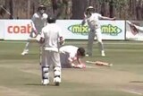 David Warner on the ground after being hit on the neck