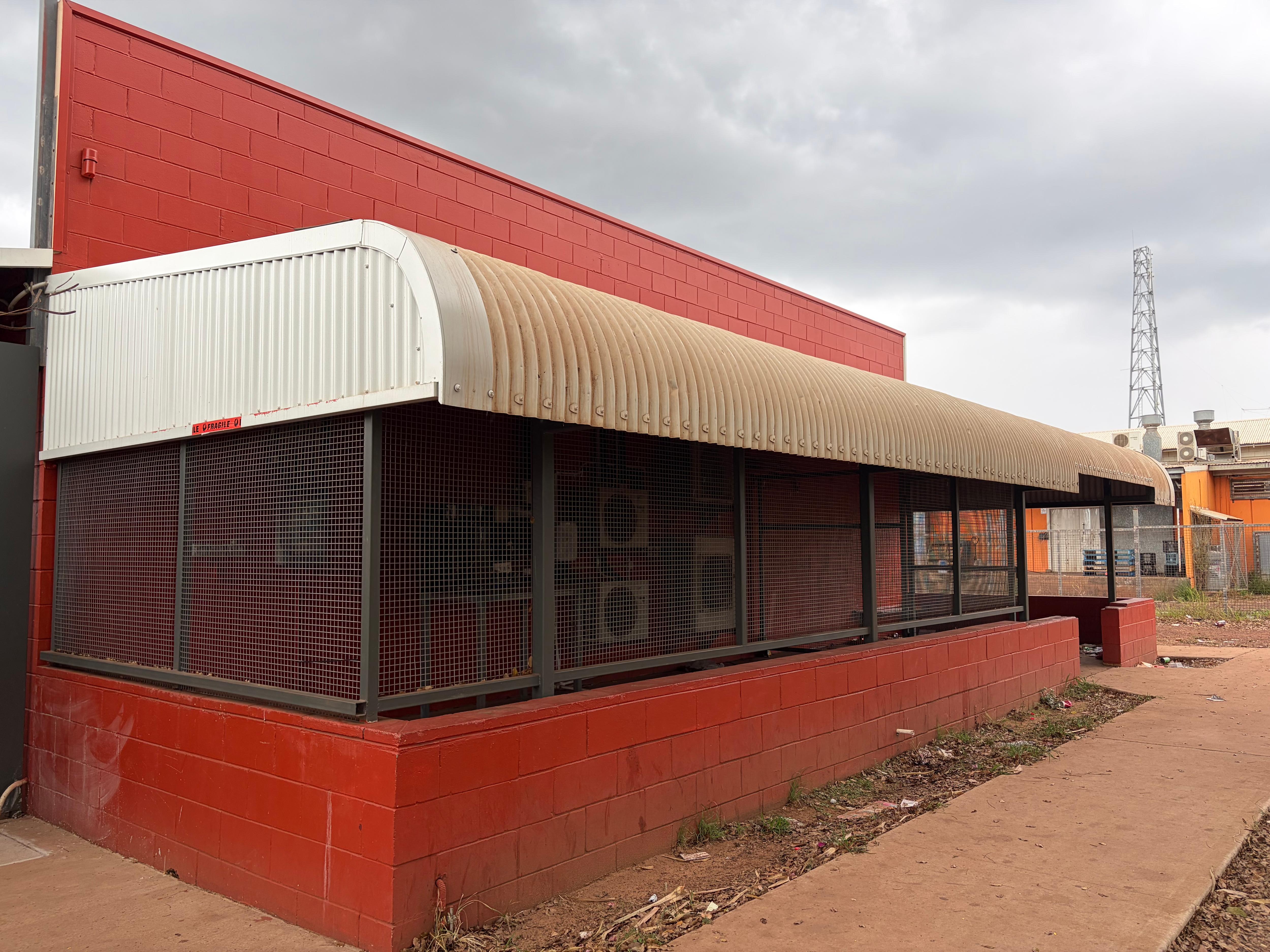 The Wadeye Social club closed with a cage around it.