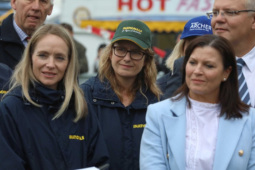 Deanna Hutchinson and Sally Milbourne wear Nationals branded clothing as they stan alongside Scott and Jenny Morrison