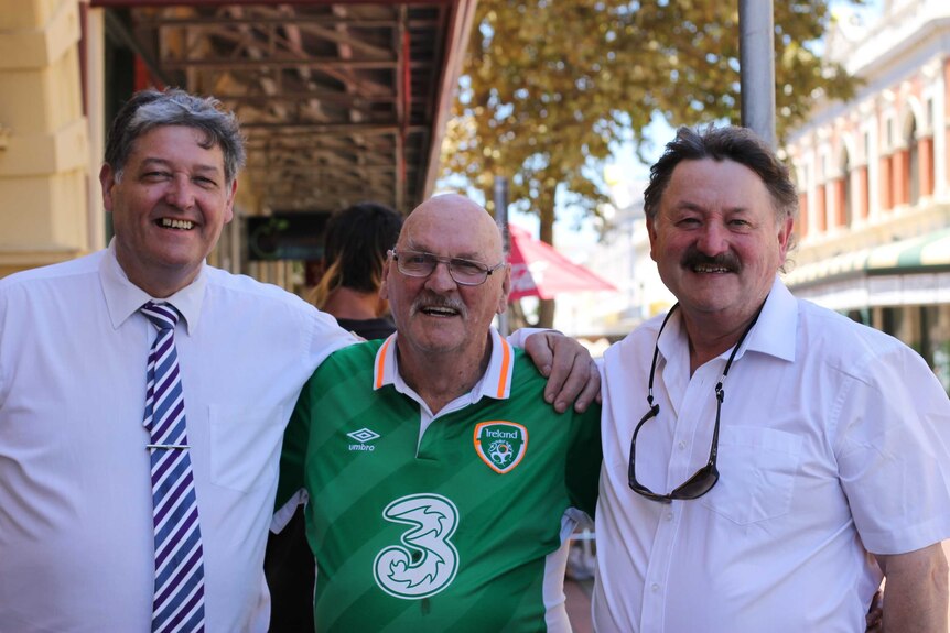 Paddy Cannon with his brothers, Michael Derrig (left) and John Joe Derrig (right) standing on the street in Fremantle