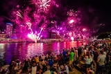 People watch fireworks on New Year's Eve over the Brisbane River at South Bank on December 31, 2018.