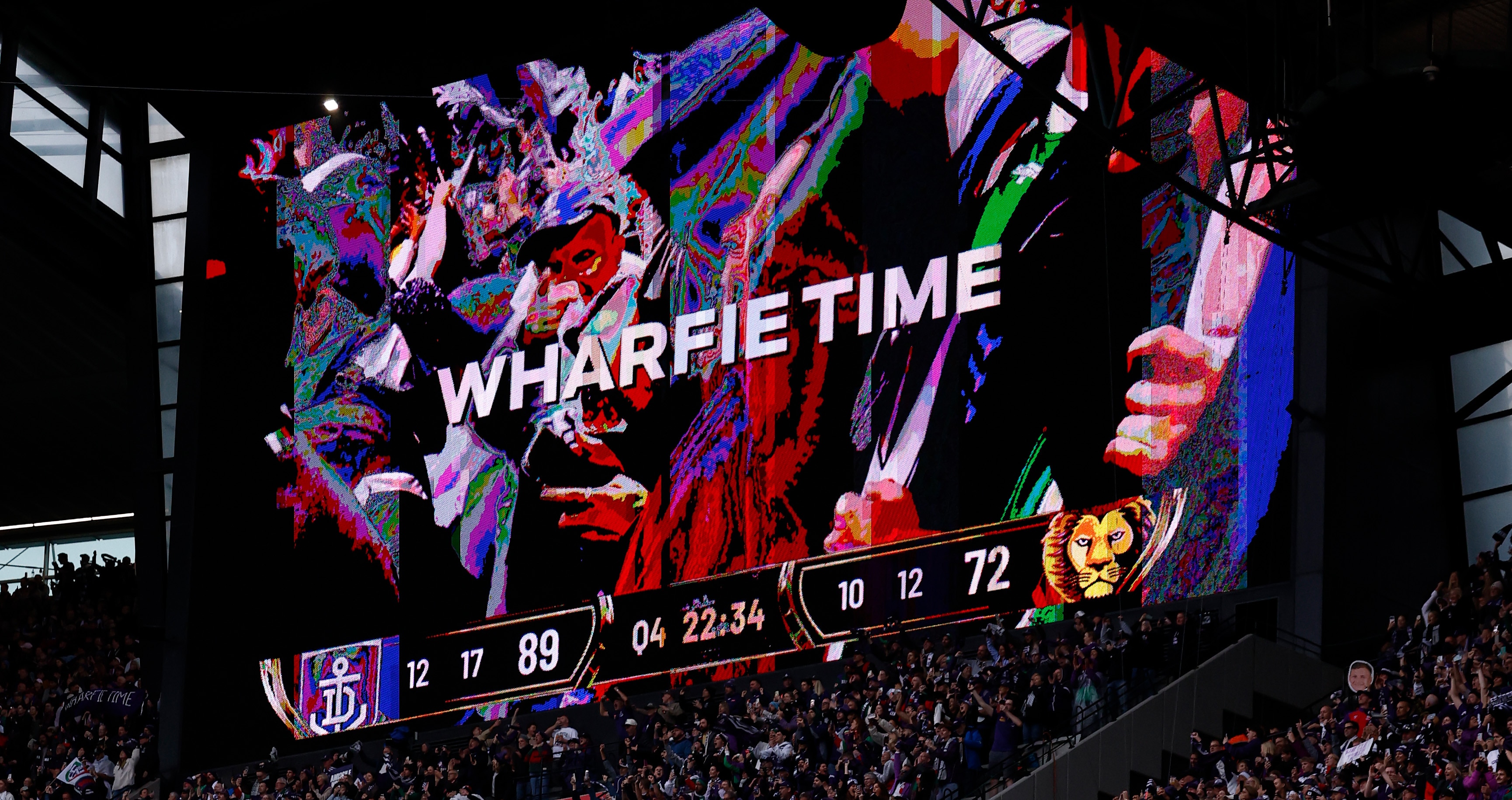 The scoreboard at the MCG shows the Wharfie Time symbol