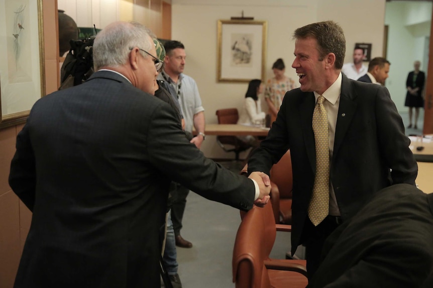 Scott Morrison shakes hands with Dan Tehan