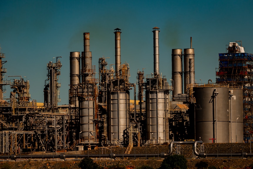 A gas plant, with smoke emitting from chimneys.