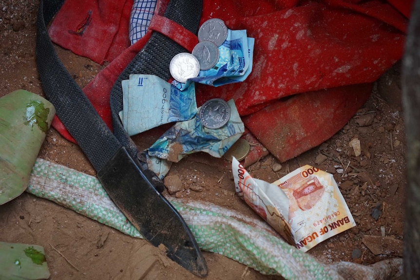 Blood drips at Sullaih's feet where money is collecting after his circumcision.