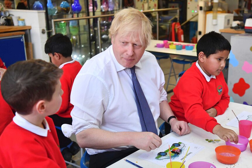 Britain's Prime Minister Boris Johnson participates in a workshop with children.